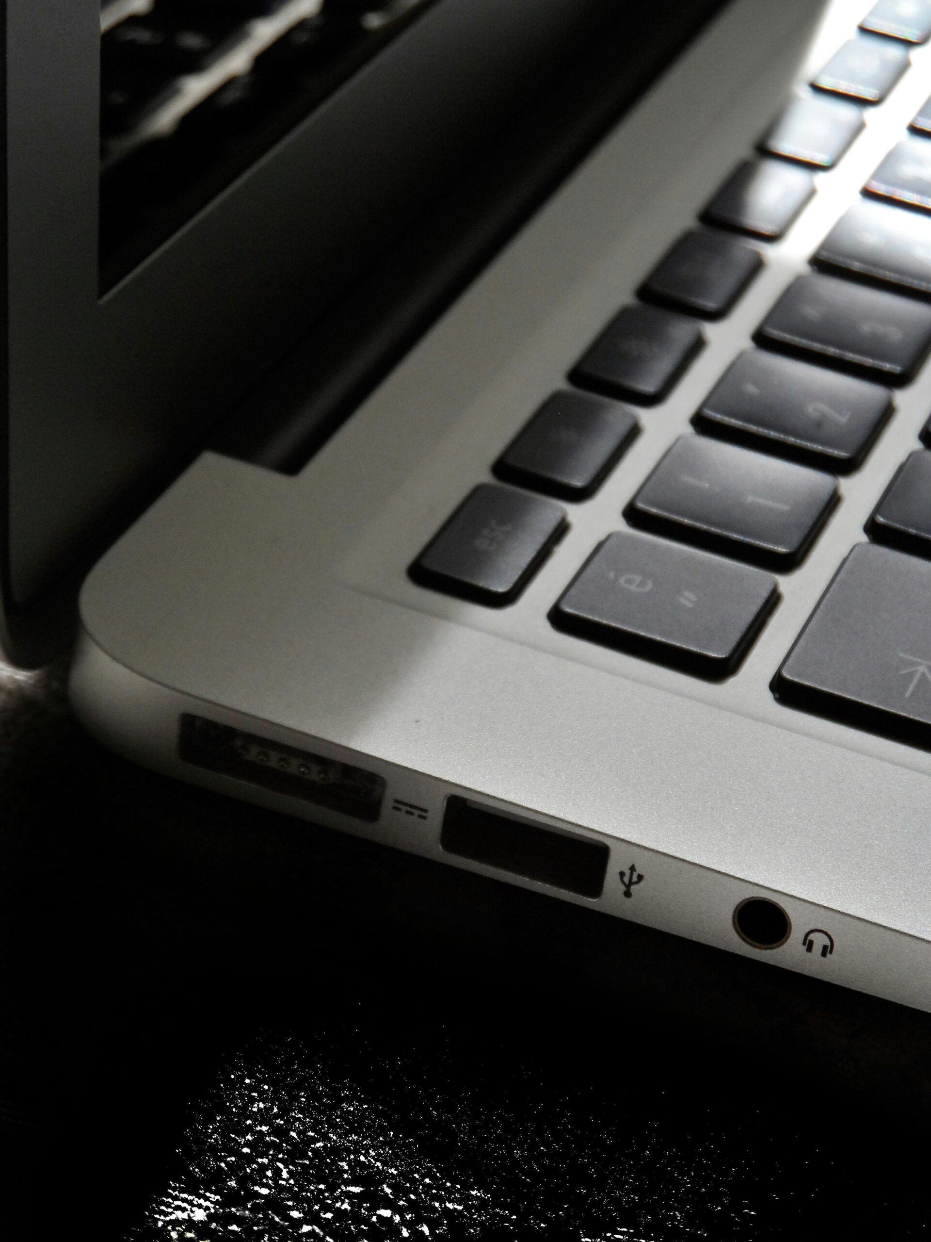 The-Zombie-SaaS-Audit_-Finding-the-3-Apps-Your-Former-Employees-Still-Access-scaled.jpg Free Detailed view of a silver laptop showing keyboard and multiple ports. Stock Photo